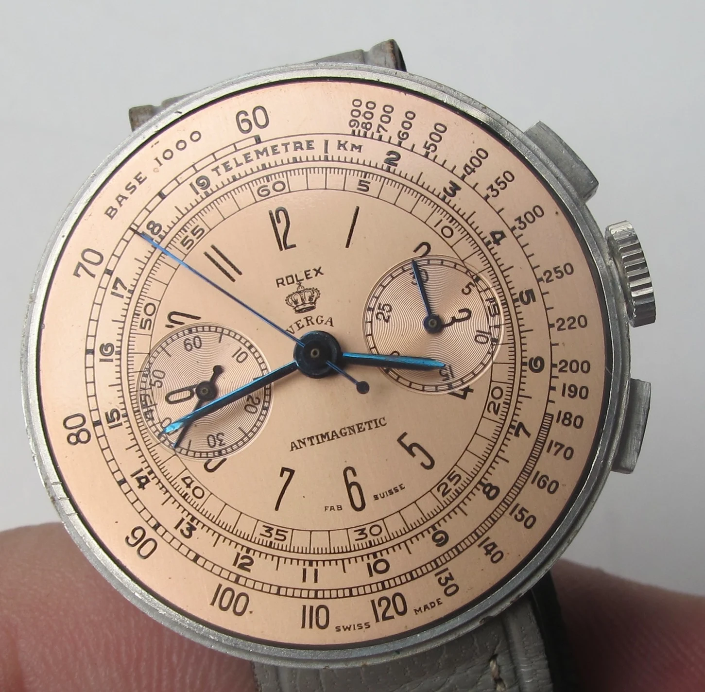 Crystal-on lead view of the Rolex reference 3233 Disco Volante chronograph with salmon multi-scale dial and blued hands