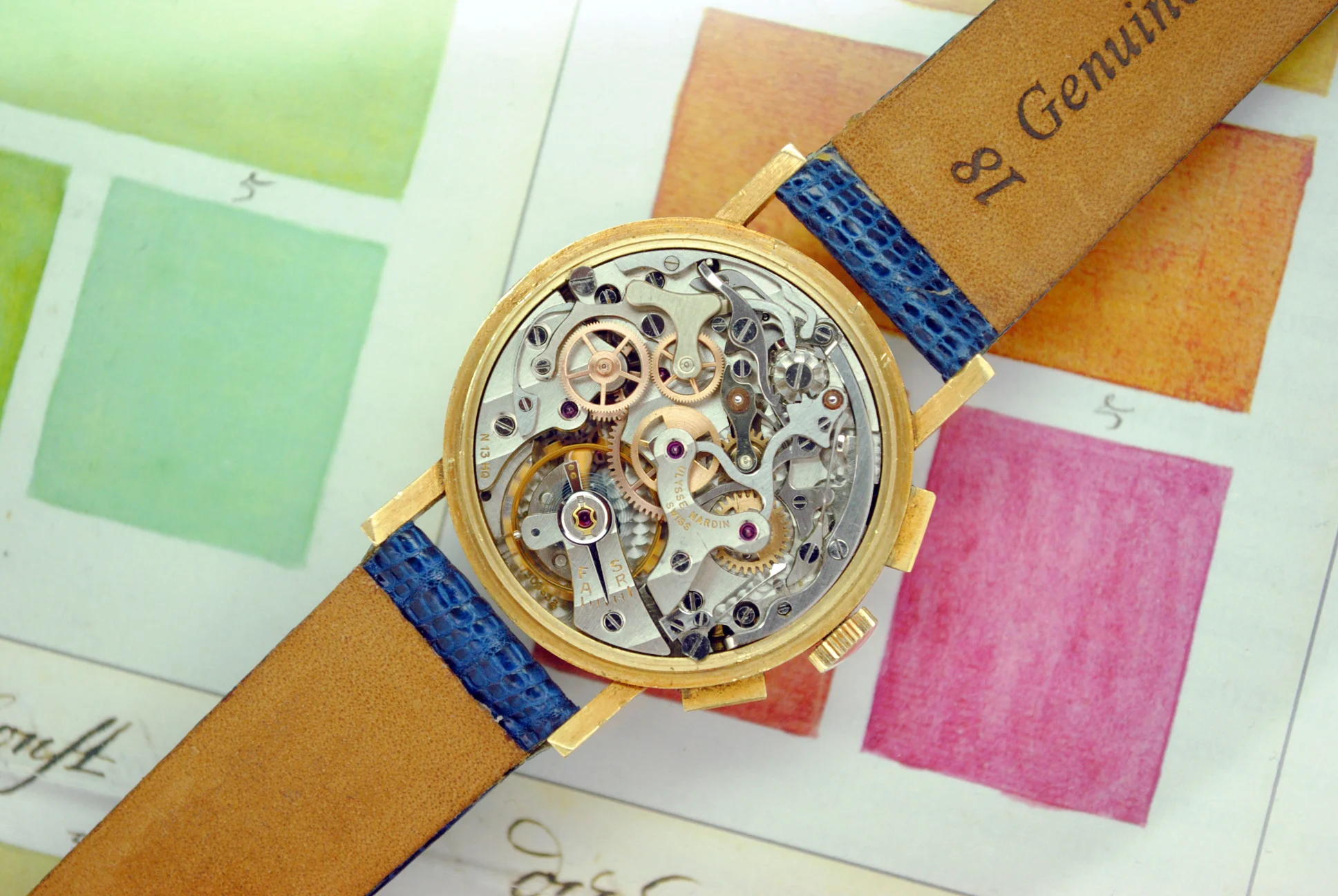Exposed Ulysse Nardin signed manual-winding chronograph movement inside the sold rose-gold watch