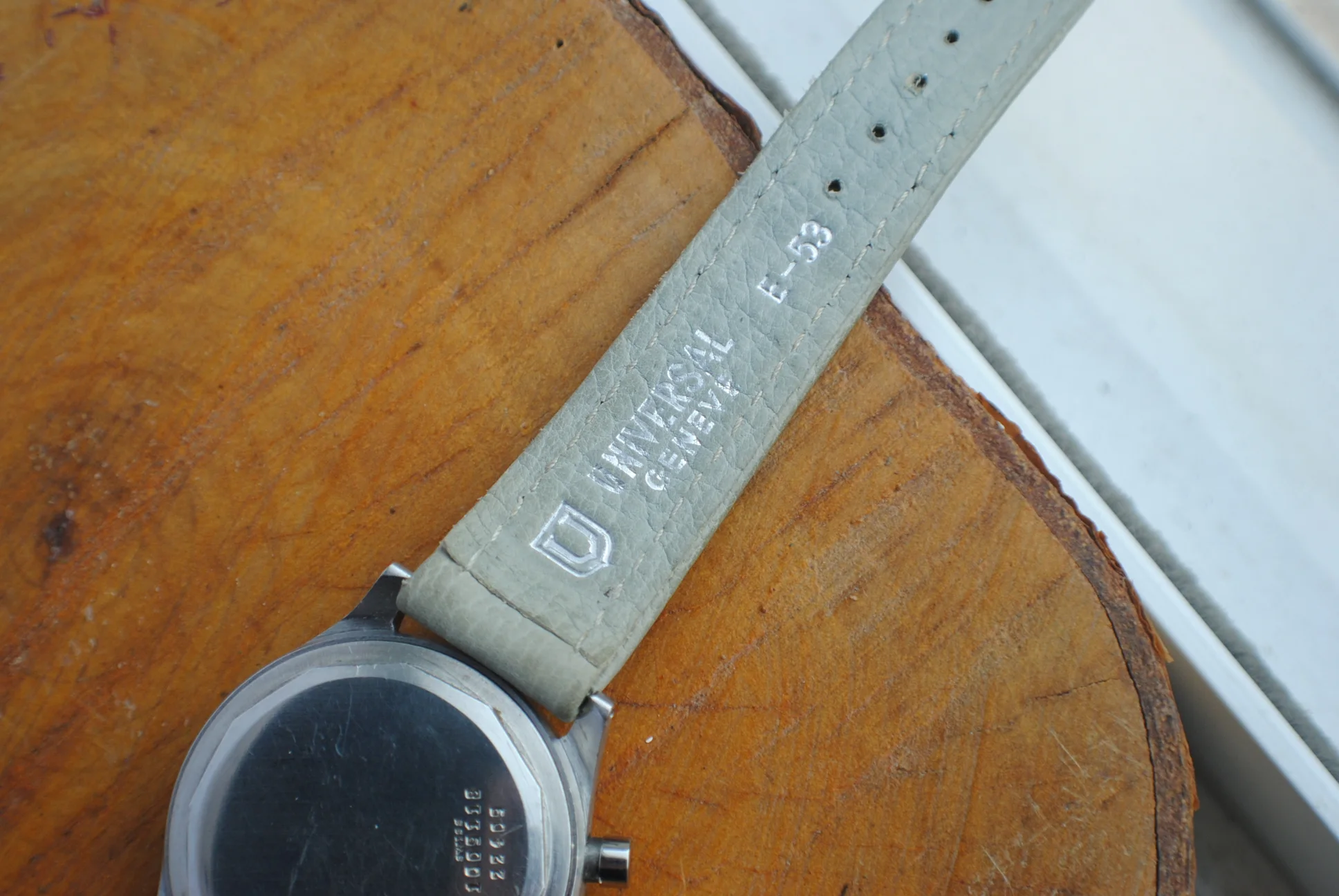 Close documentary view of the Universal Genève-signed leather strap and caseback
