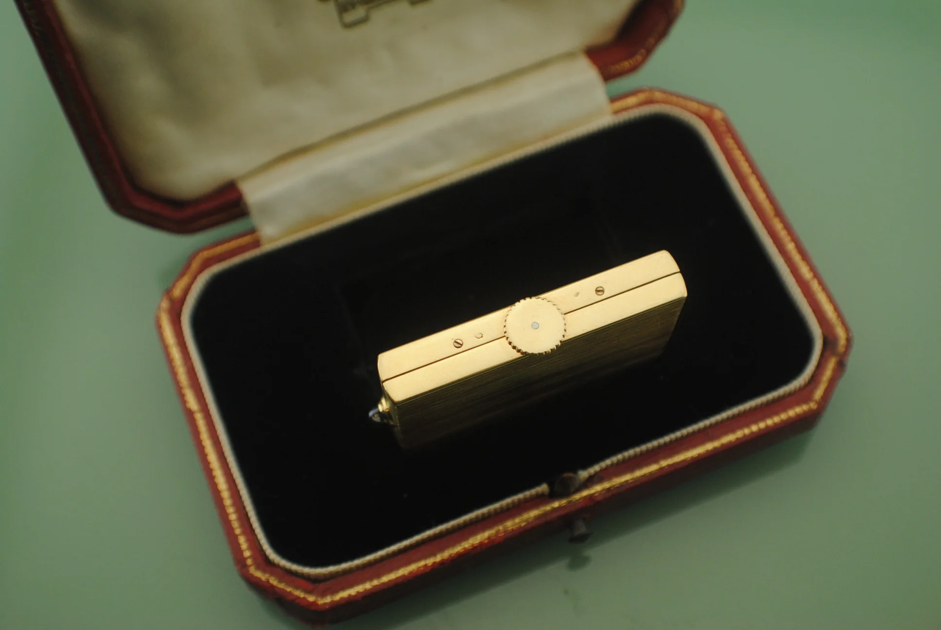 Opposite angled side view of the closed Cartier Guillotine watch in its fitted presentation box