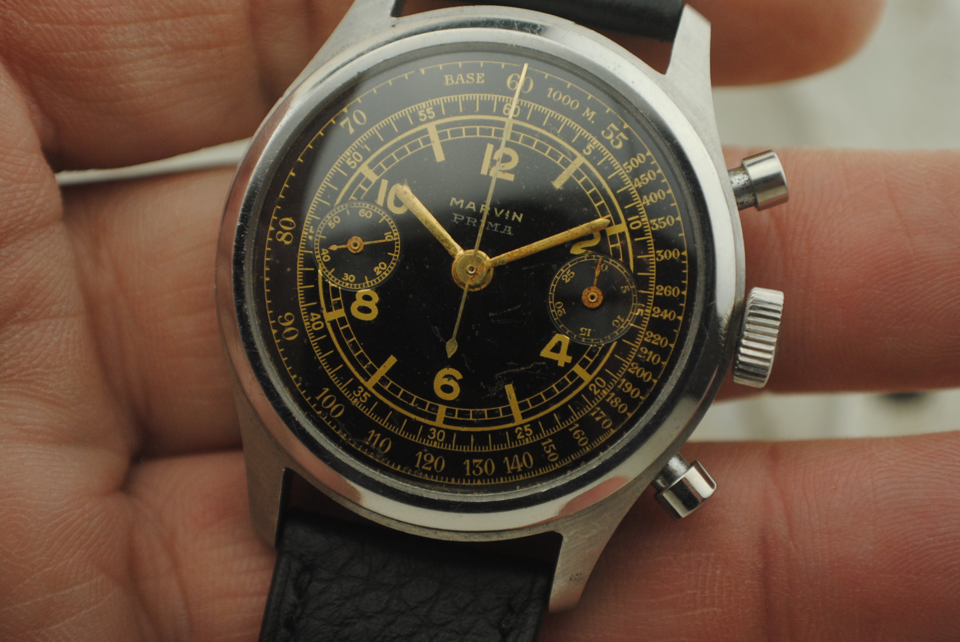 Open Marvin chronograph beside the removed screw-down caseback