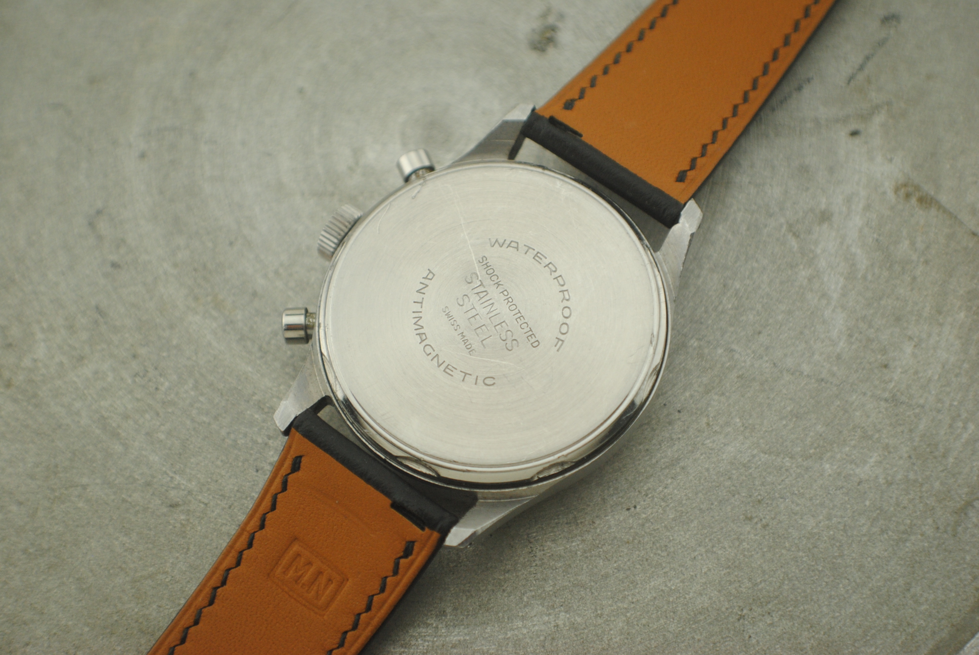 Exterior screw-down caseback of the Marvin stainless-steel chronograph with waterproof and antimagnetic markings