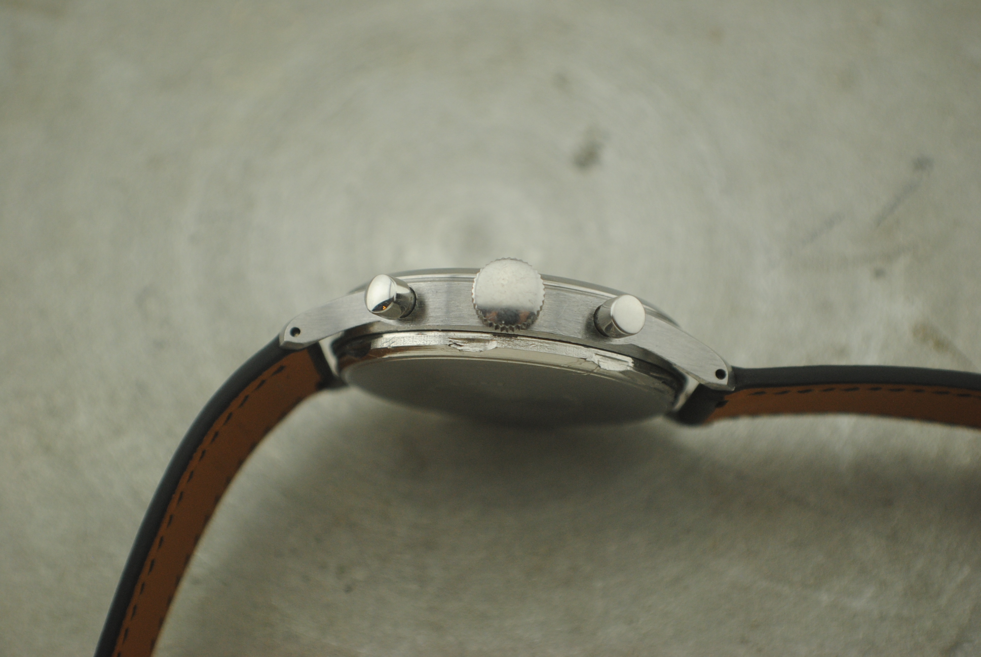 Full profile view of the Marvin stainless-steel chronograph with its leather strap